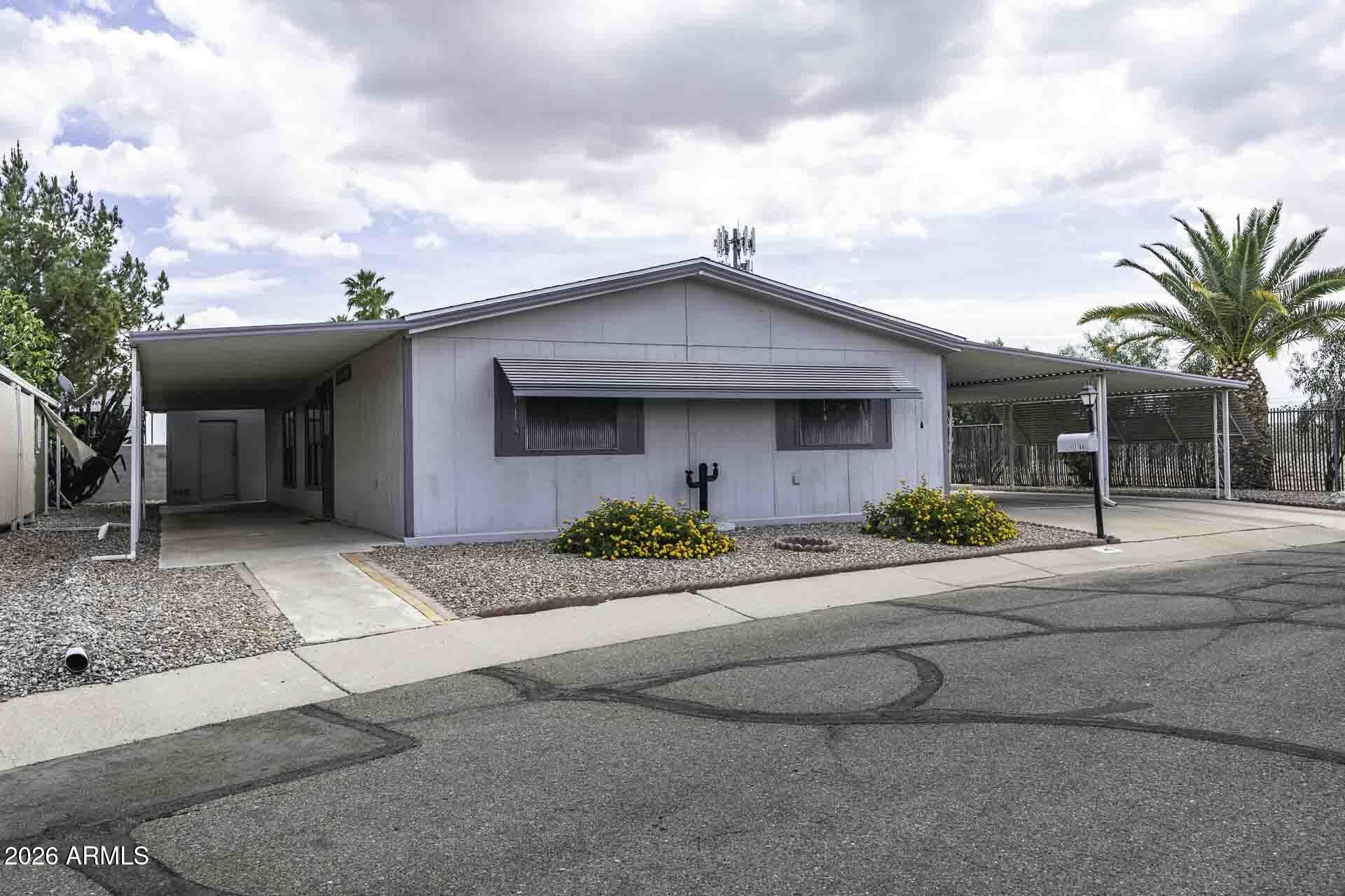 2100 North Trekell Road, Unit 143 Casa Grande, AZ 85122 - Photo 2 of 34 a front view of a house with yard and garage