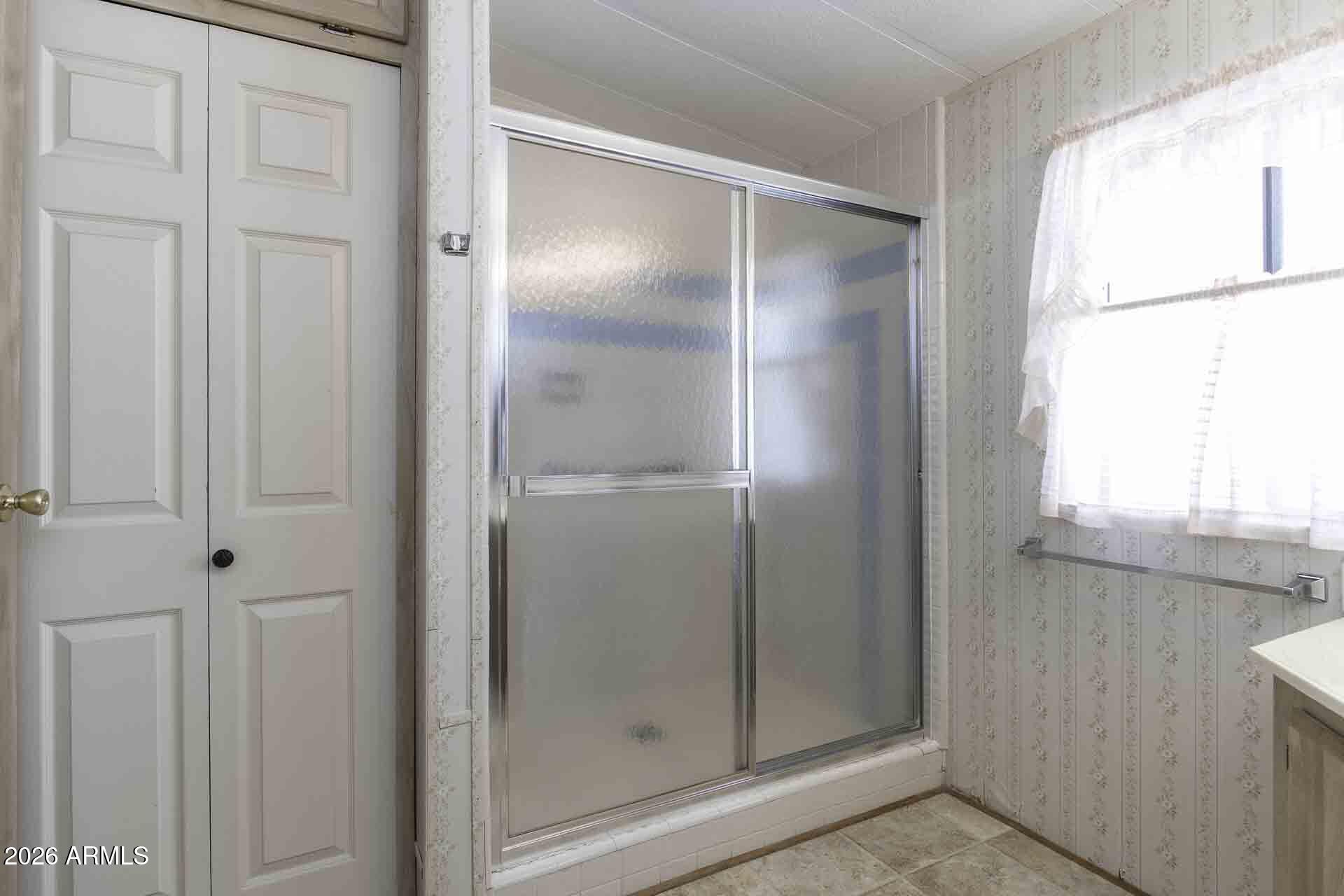 2100 North Trekell Road, Unit 143 Casa Grande, AZ 85122 - Photo 27 of 34 a bathroom with a glass shower door