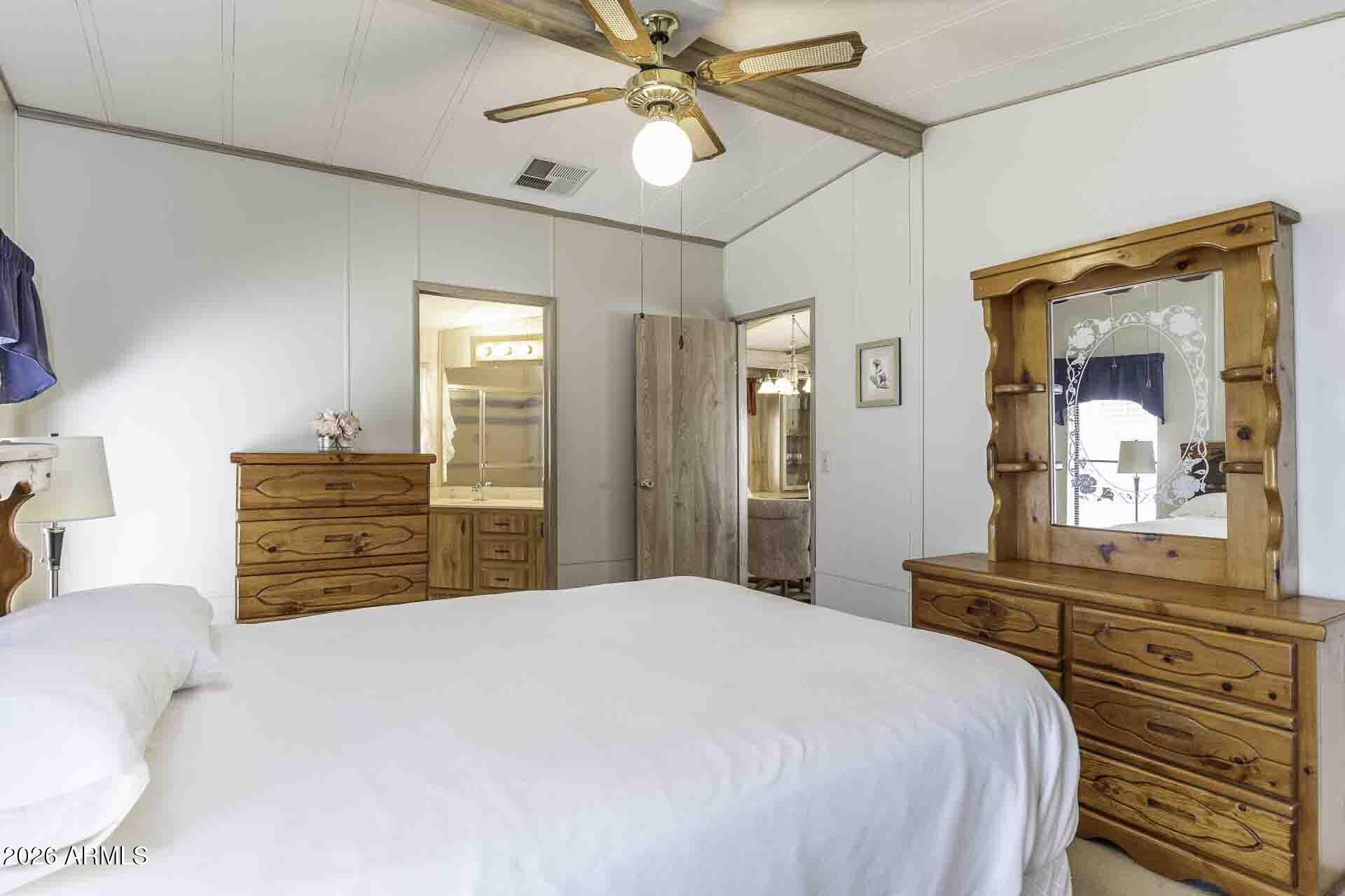 2100 North Trekell Road, Unit 143 Casa Grande, AZ 85122 - Photo 29 of 34 a bedroom with a bed and a chandelier