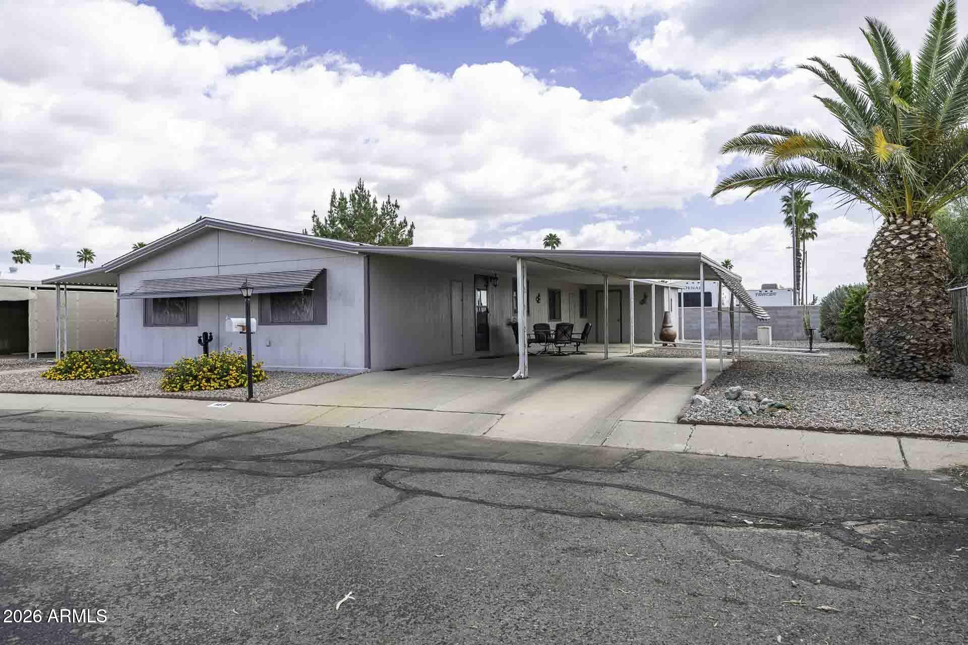 2100 North Trekell Road, Unit 143 Casa Grande, AZ 85122 - Photo 3 of 34 a view of a house with outdoor space and palm trees