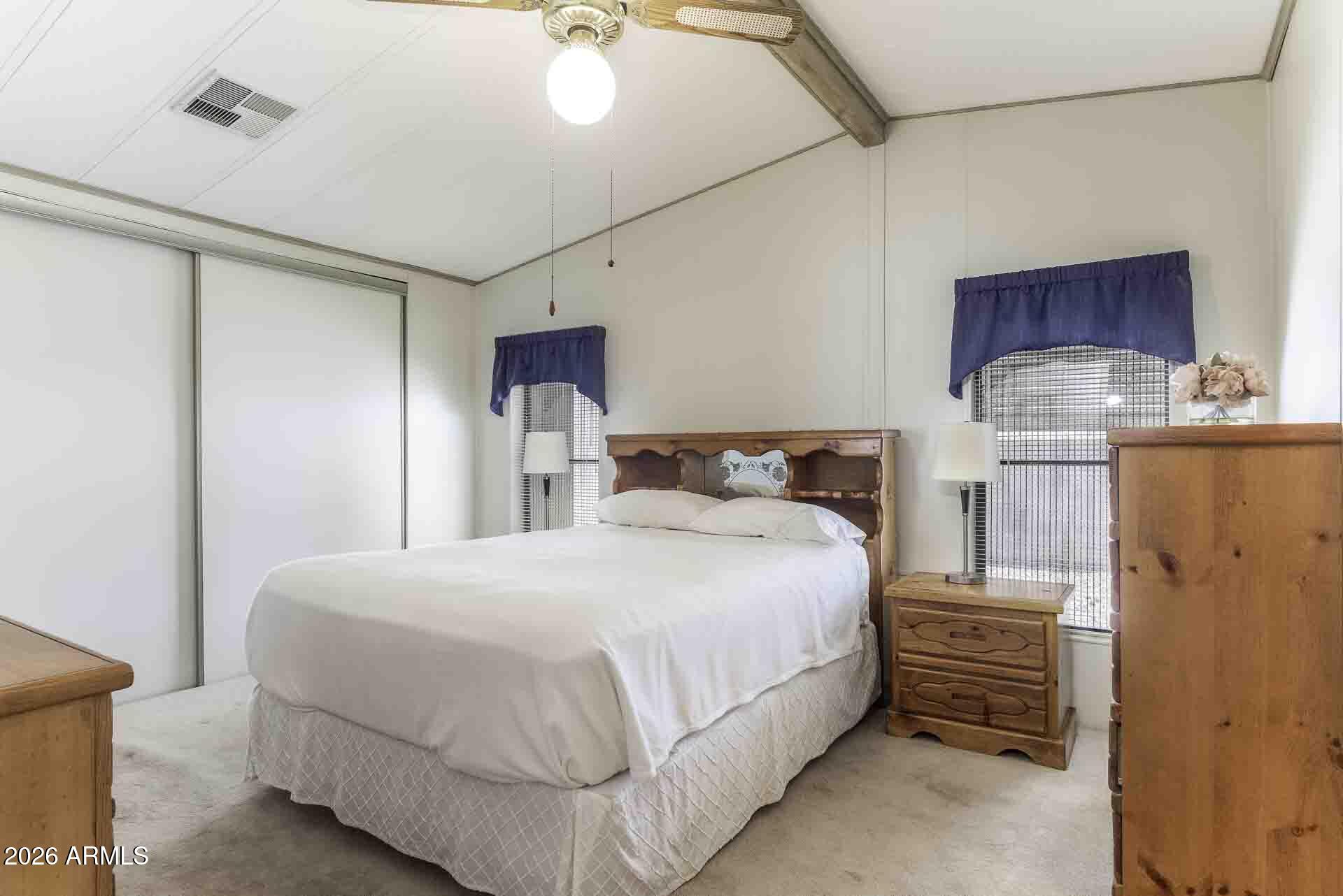 2100 North Trekell Road, Unit 143 Casa Grande, AZ 85122 - Photo 30 of 34 a bedroom with a bed and wooden floor