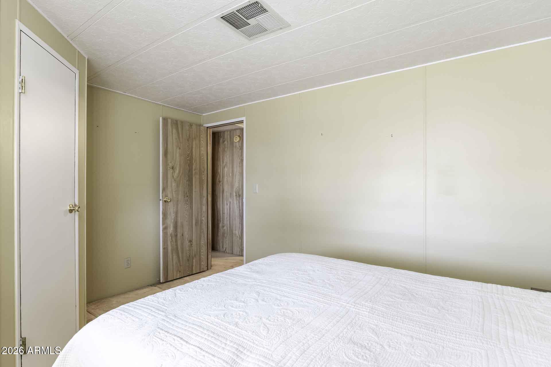 2100 North Trekell Road, Unit 143 Casa Grande, AZ 85122 - Photo 7 of 34 a bedroom with a bed and a ceiling fan