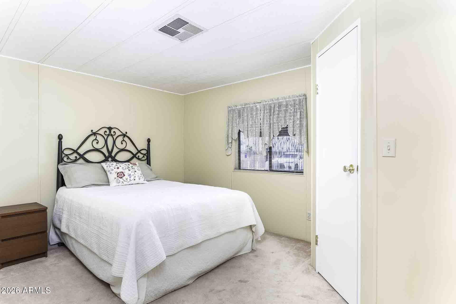 2100 North Trekell Road, Unit 143 Casa Grande, AZ 85122 - Photo 8 of 34 a bedroom with a bed and a painting on the wall