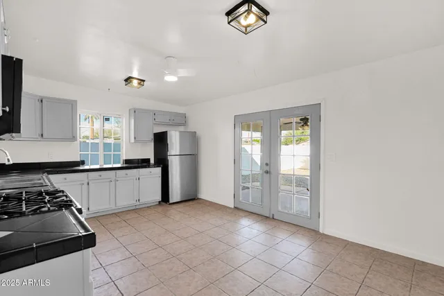 a kitchen with granite countertop a stove and a refrigerator