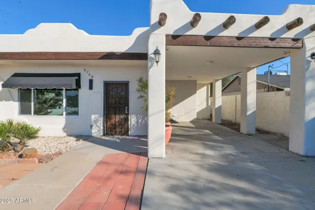 a view of a patio with table and chairs