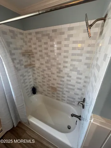 a bathroom with a sink a toilet a tub and a window