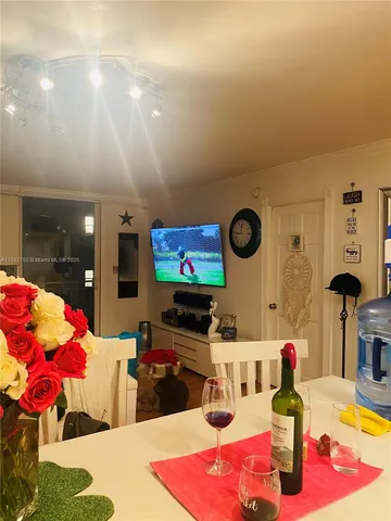 a view of a dining room with furniture and potted plants