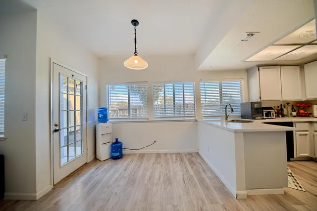 a bedroom with a bed a flat screen tv and a window