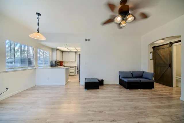 a bedroom with a bed and a flat tv screen on wall