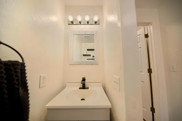 a spacious bathroom with a sink and a mirror