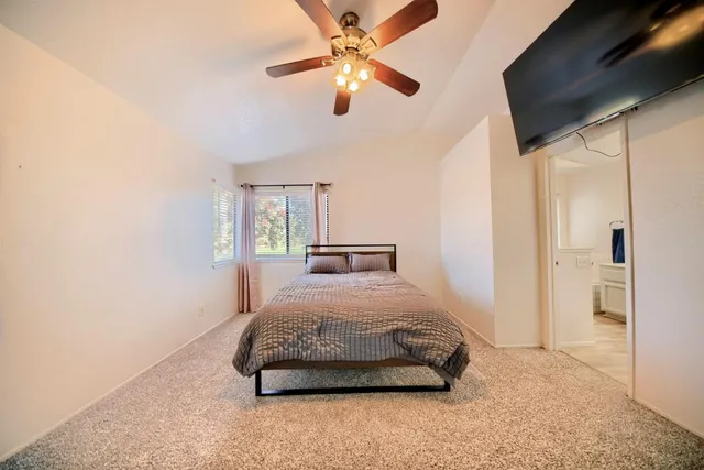 a front view of a house with a garden and trees