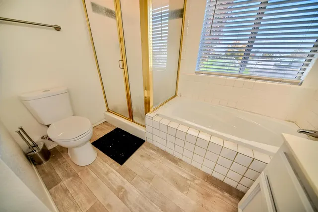 a front view of house with yard and trees in the background