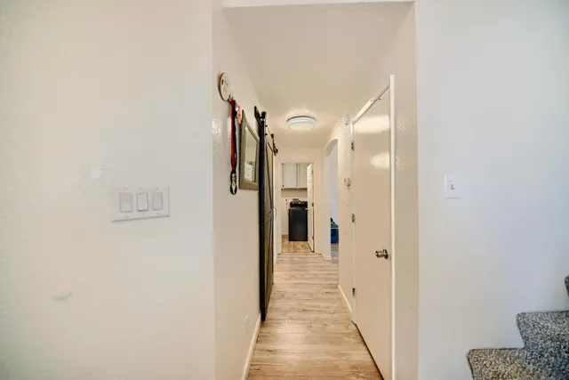 a view of entryway and hall with wooden floor