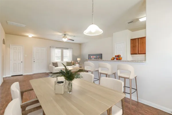 a living room with furniture dining table and wooden floor