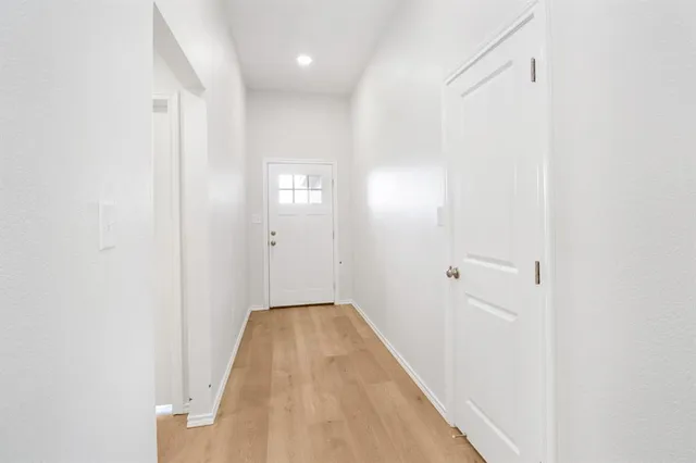 a view of a room with wooden floor and bathroom