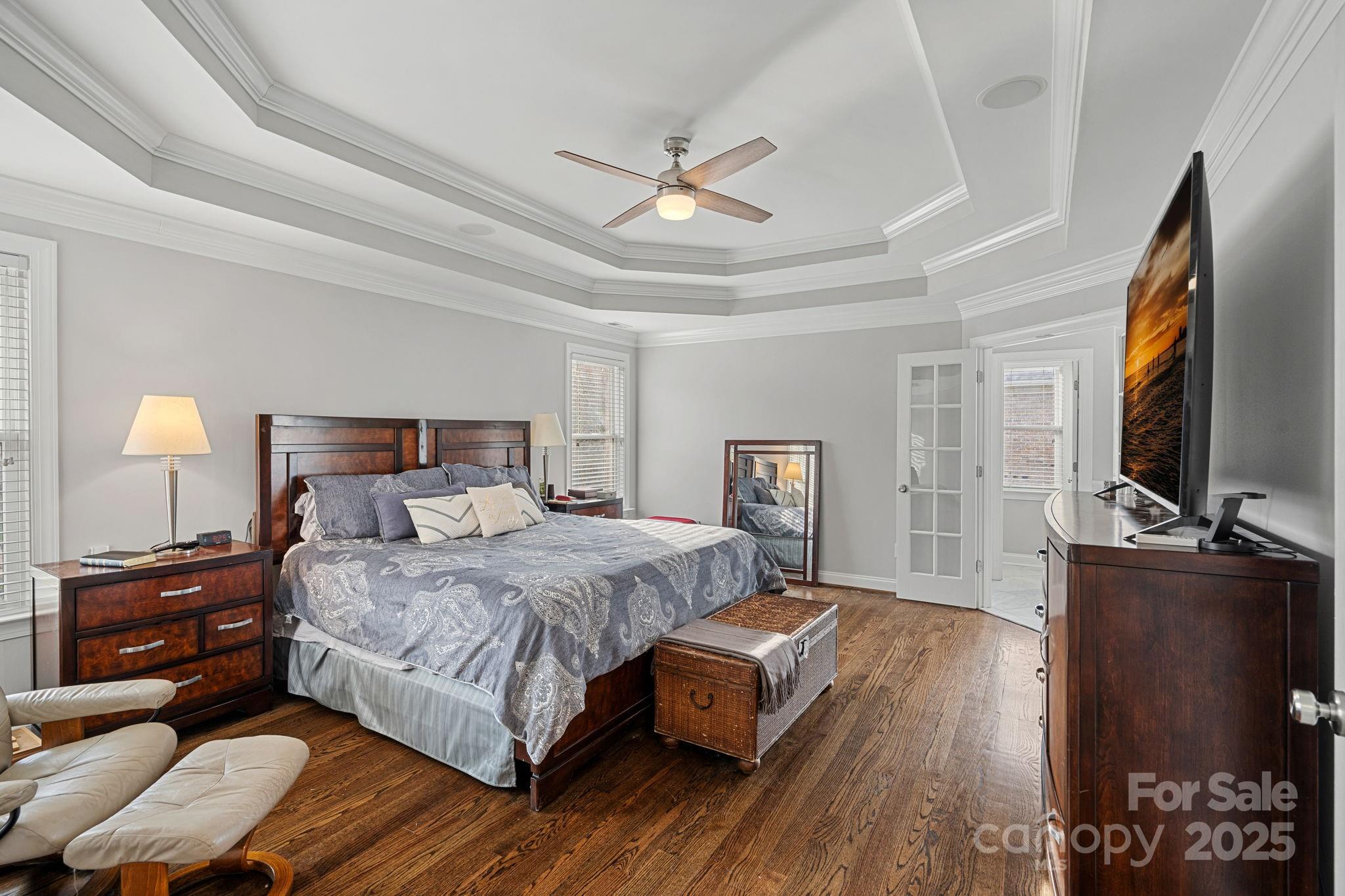 18334 Dembridge Drive Davidson, NC 28036 - Photo 17 of 35 a bedroom with a bed and a flat screen tv