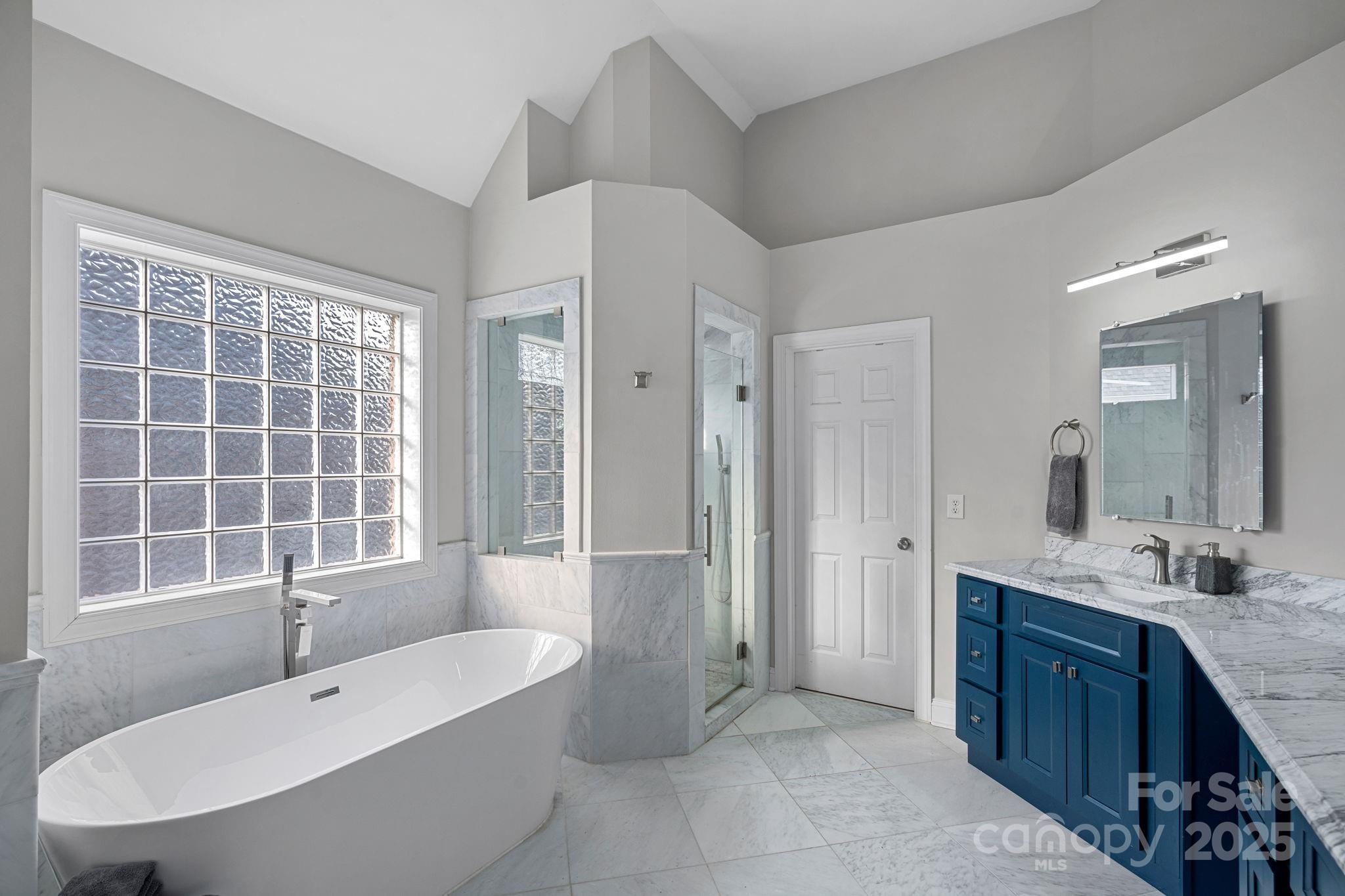 18334 Dembridge Drive Davidson, NC 28036 - Photo 18 of 35 a large spacious bathroom with a granite countertop tub sink shower and mirror