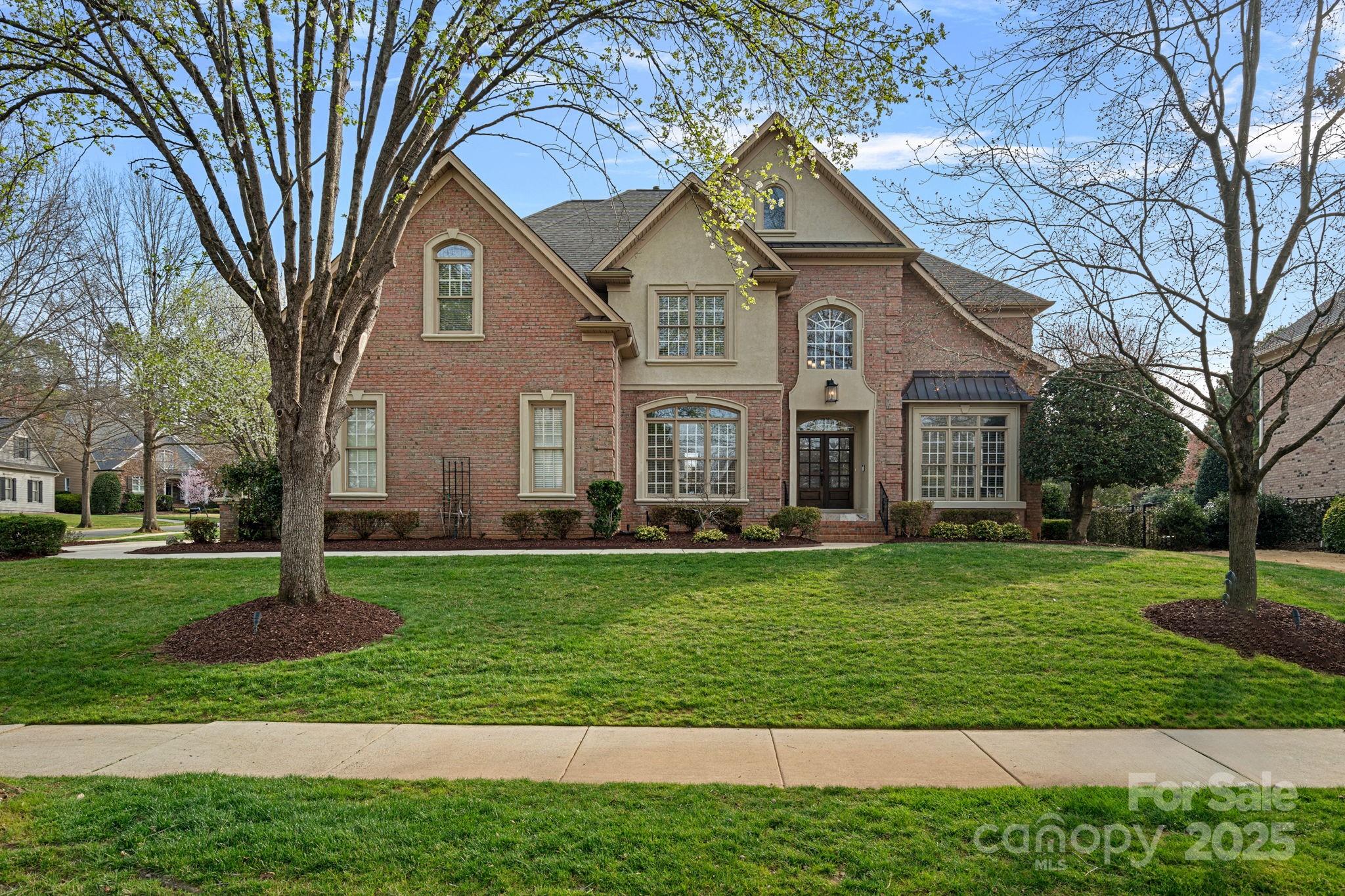18334 Dembridge Drive Davidson, NC 28036 - Photo 2 of 35 a front view of a house with a yard