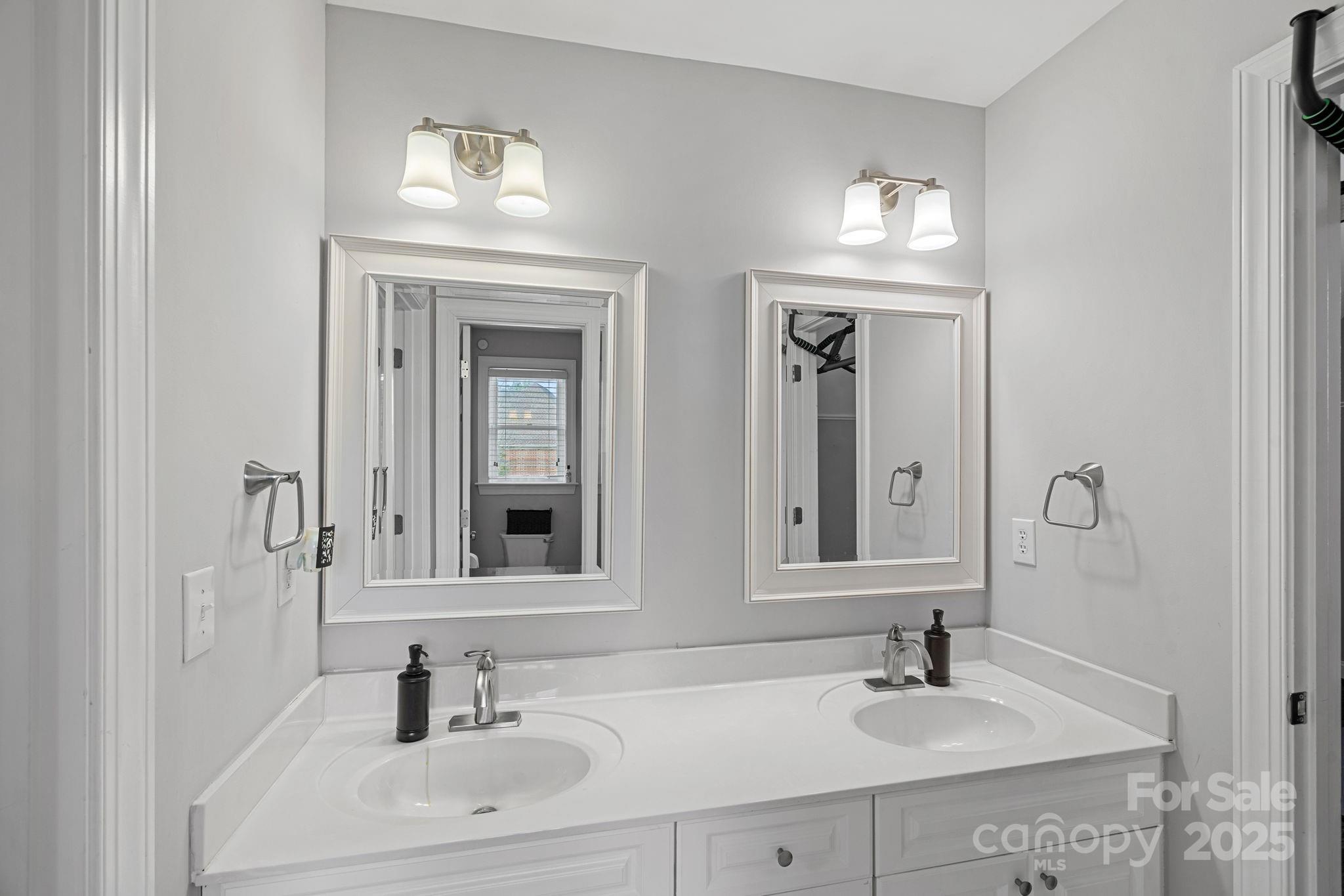 18334 Dembridge Drive Davidson, NC 28036 - Photo 25 of 35 a bathroom with double vanity sinks and a mirror