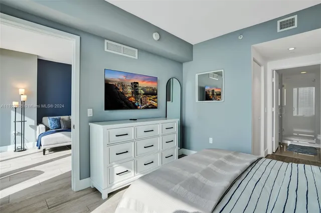 a bedroom with a bed and a flat screen television