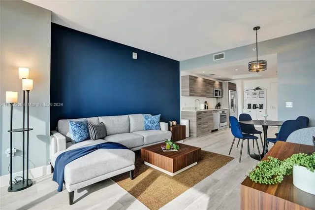 a living room with furniture and wooden floor