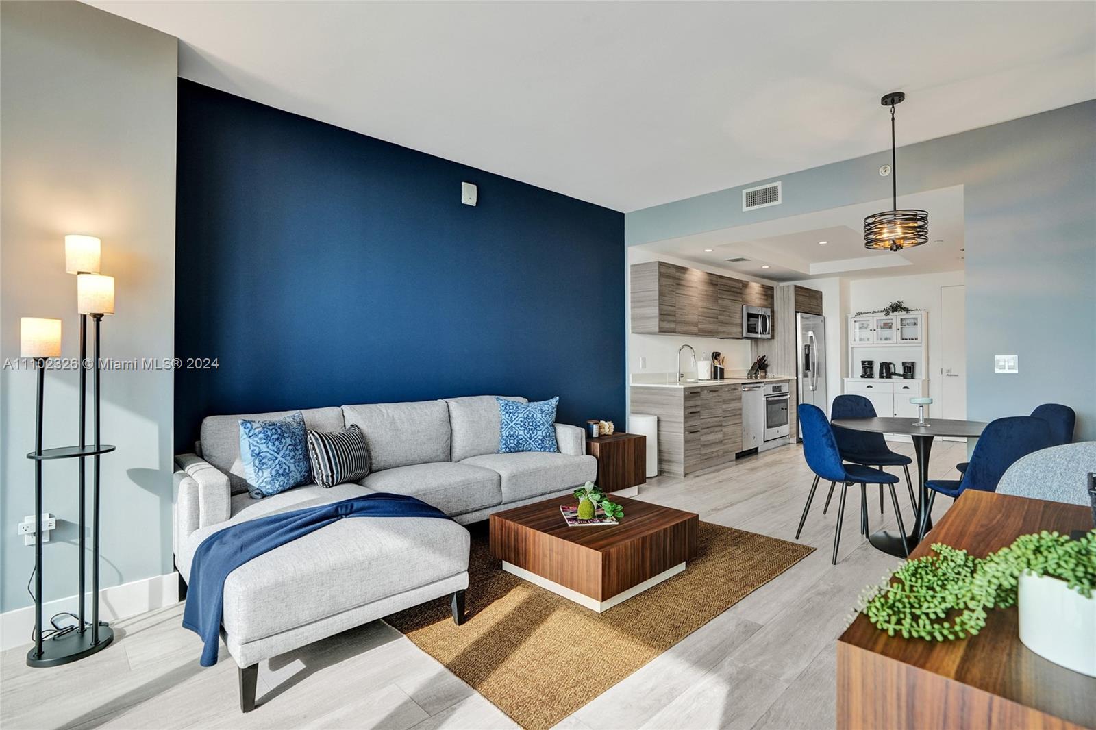 121 Northeast 34th Street, Unit 2906 Miami, FL 33137 - Photo 3 of 65 a living room with furniture and wooden floor