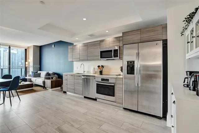 a kitchen with cabinets and stainless steel appliances