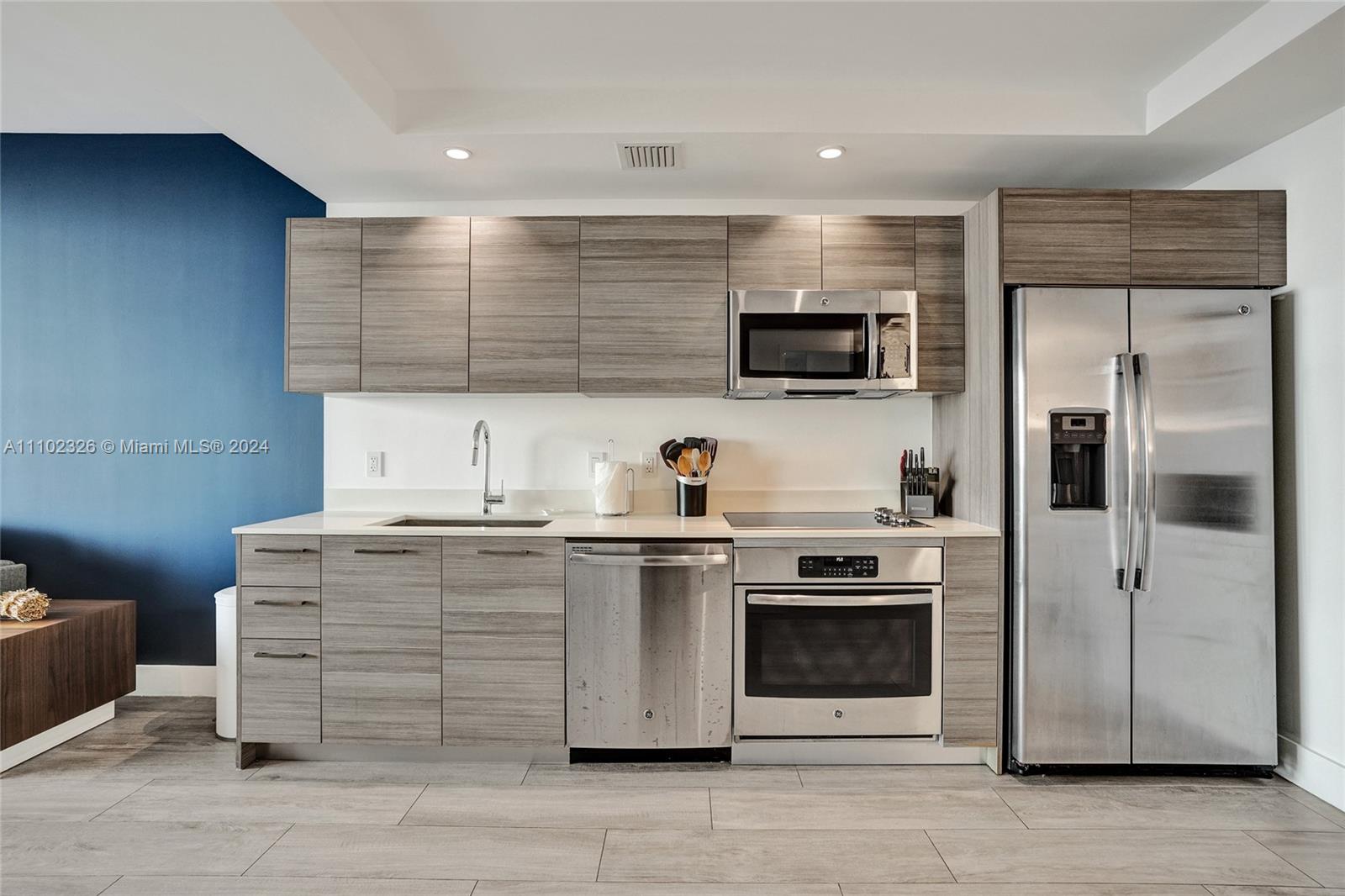 121 Northeast 34th Street, Unit 2906 Miami, FL 33137 - Photo 9 of 65 a kitchen with stainless steel appliances granite countertop a stove and a refrigerator
