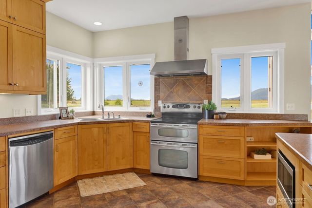 a kitchen with appliances cabinets and a sink