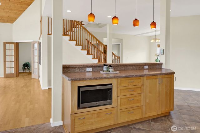 a large kitchen with a lot of counter space and stainless steel appliances