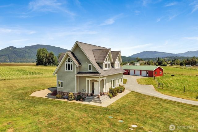a view of a house with a big yard and potted plants