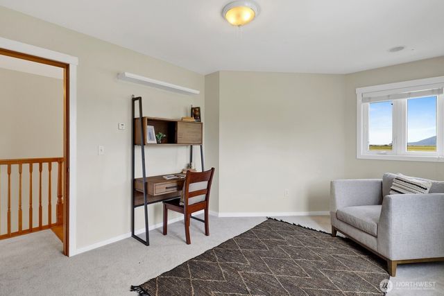 a front view of house with yard and trees in the background