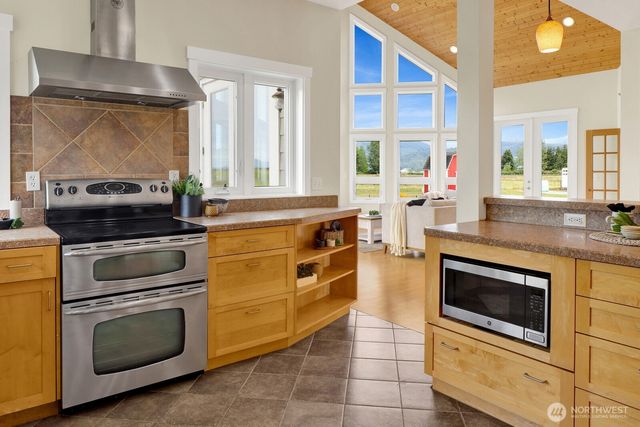 a dining room with furniture a chandelier and wooden floor