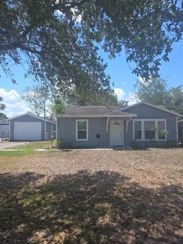 a front view of house with yard and trees