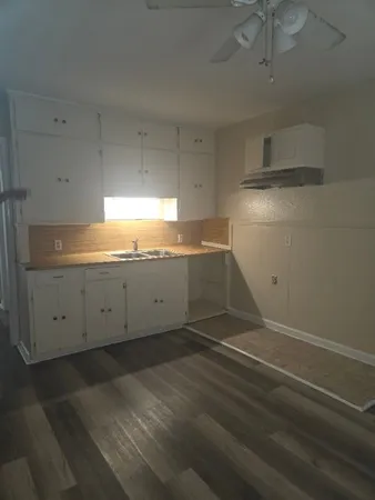 a view of a kitchen with white cabinets