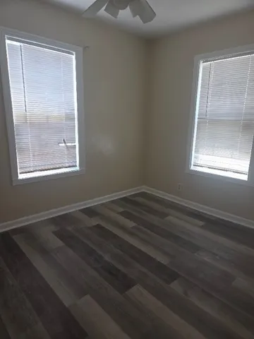 a room with a window and a wooden floor