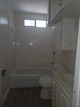 a bathroom with a shower a toilet and sink