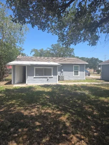 a front view of house with yard barbeque and outdoor seating