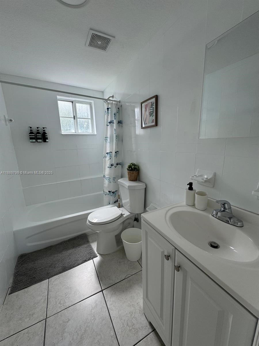 328 Northwest 12th Avenue, Unit 8 Miami, FL 33128 - Photo 12 of 15 a bathroom with a sink a toilet and mirror