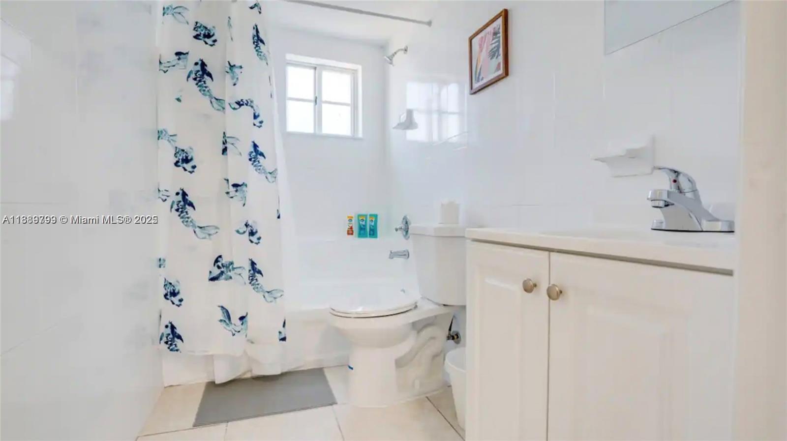 328 Northwest 12th Avenue, Unit 8 Miami, FL 33128 - Photo 13 of 15 a white toilet sitting next to a bathroom sink