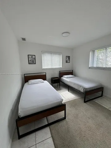 a spacious bedroom with two beds and a couch