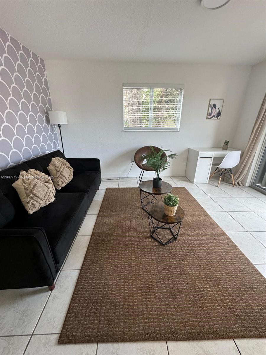328 Northwest 12th Avenue, Unit 8 Miami, FL 33128 - Photo 2 of 15 a living room with furniture and a rug