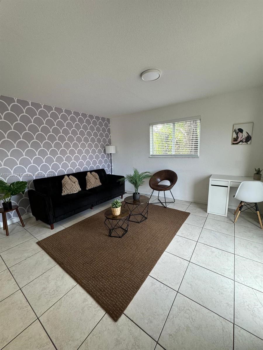 328 Northwest 12th Avenue, Unit 8 Miami, FL 33128 - Photo 3 of 15 a living room with furniture and a fireplace