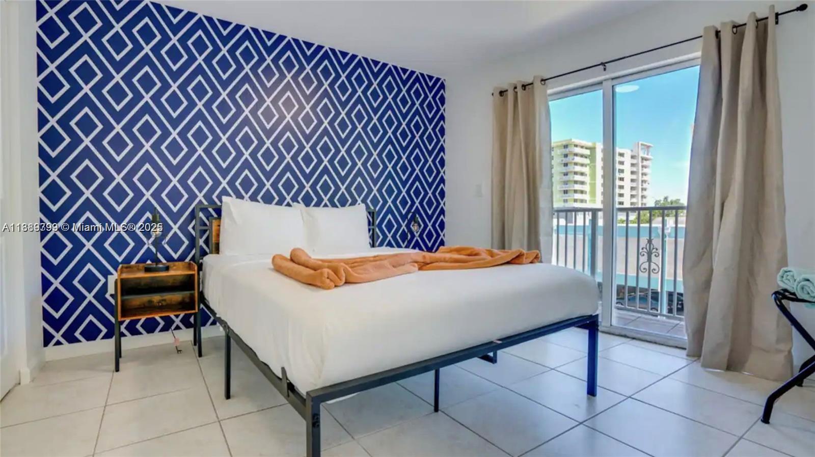 328 Northwest 12th Avenue, Unit 8 Miami, FL 33128 - Photo 9 of 15 a bed sitting in a bedroom next to a window