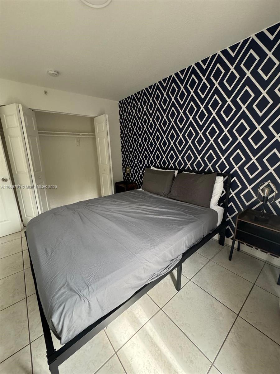 328 Northwest 12th Avenue, Unit 8 Miami, FL 33128 - Photo 10 of 15 a bedroom with a bed and a dresser