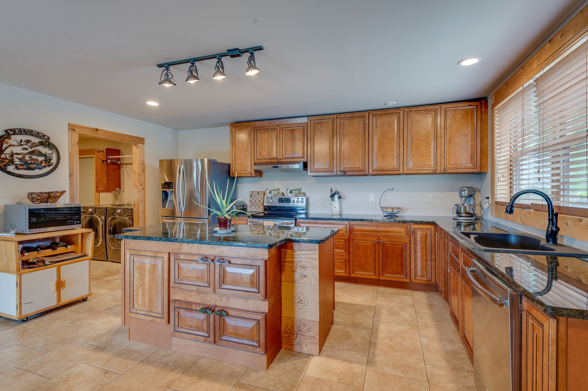1372 Cliff Amos Road Spring Hill, TN 37174 - Photo 12 of 49 a kitchen with stainless steel appliances granite countertop a stove top oven a sink dishwasher and cabinets with wooden floor