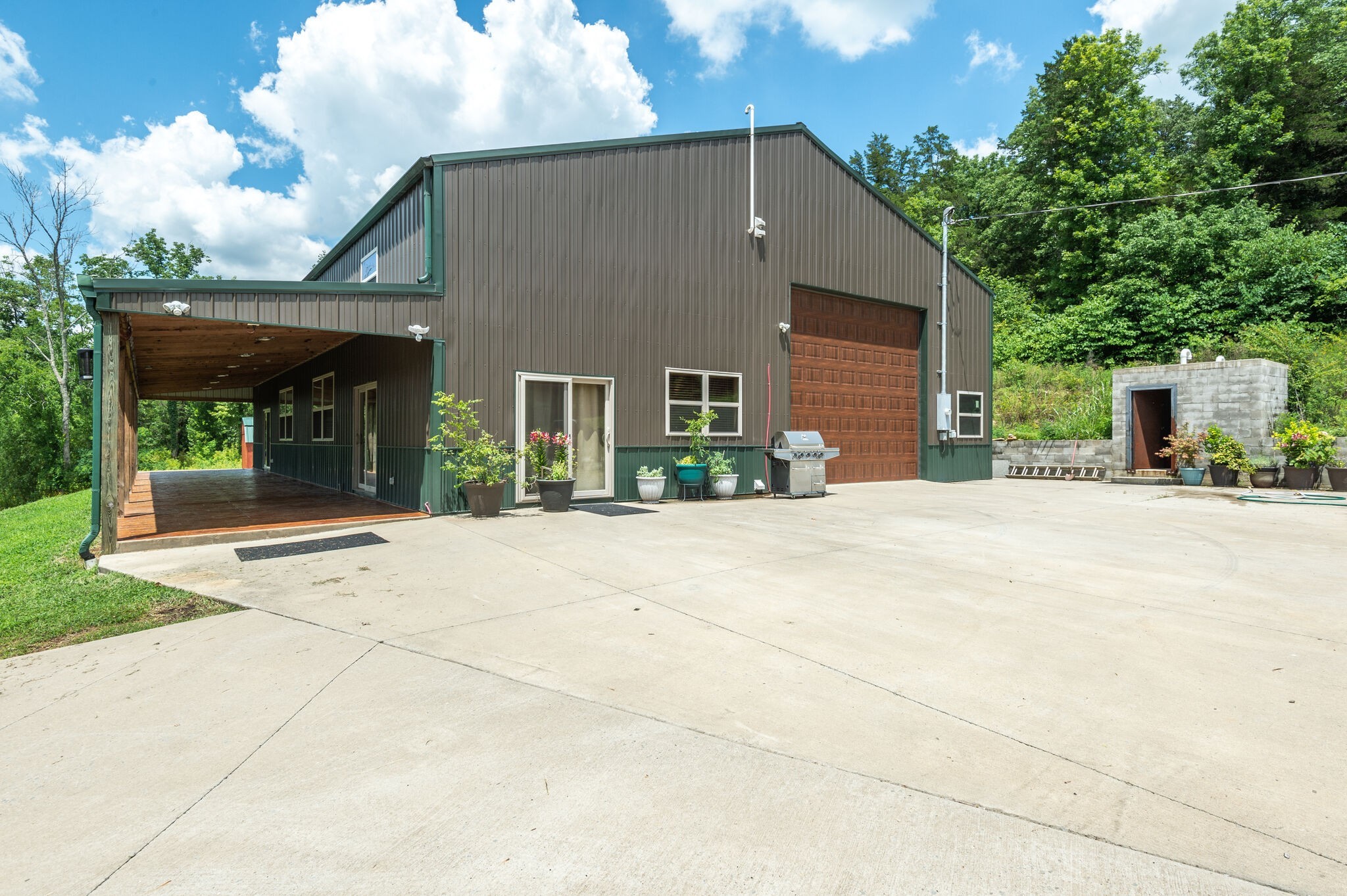1372 Cliff Amos Road Spring Hill, TN 37174 - Photo 7 of 49 a front view of a house with a yard and potted plants
