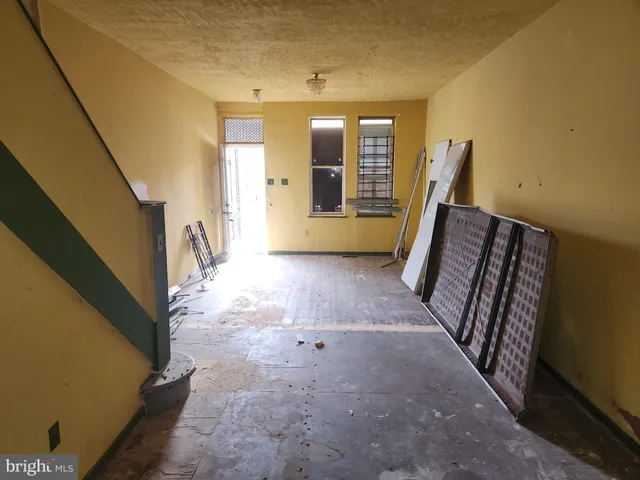 a view of a hallway with furniture and front door