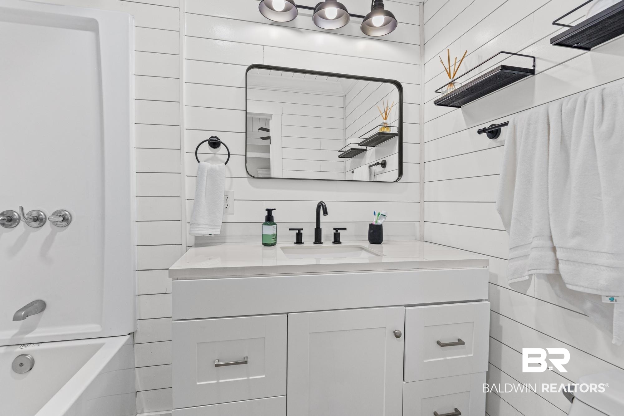 11100 Rhett McConnell Road Theodore, AL 36582 - Photo 13 of 47 Bathroom with vanity and washtub / shower combination