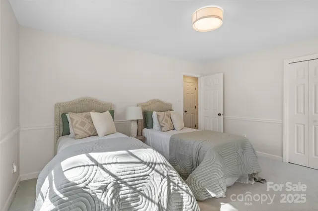 a bedroom with two beds and a mirror